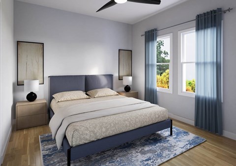 A bedroom with a large bed and a ceiling fan.