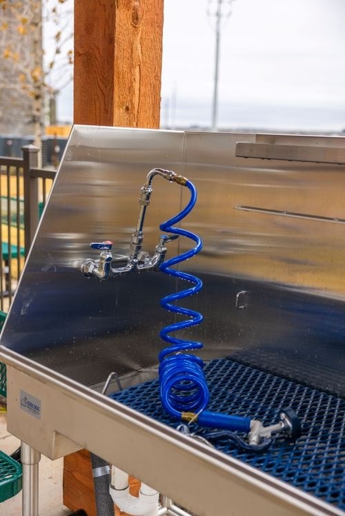 A blue spring is attached to a metal surface at Lockhart Farms Apartments, Texas