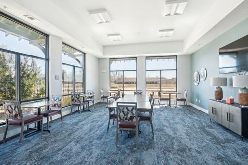 A spacious room with a dining table and chairs at Lockhart Farms Apartments, Lockhart 78644