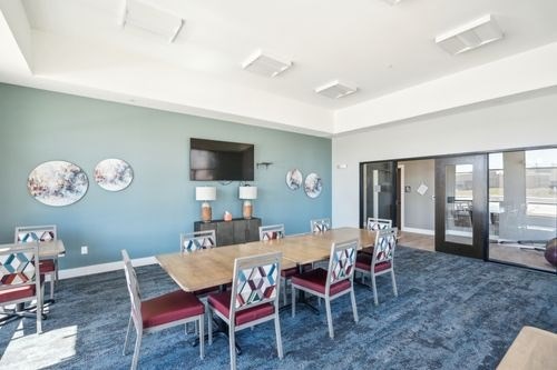 A conference room with a long table and chairs at Lockhart Farms Apartments, Lockhart, Texas