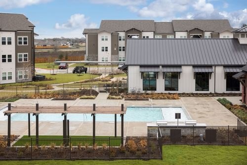 A large house with a pool in the backyard at Lockhart Farms Apartments, Lockhart, TX