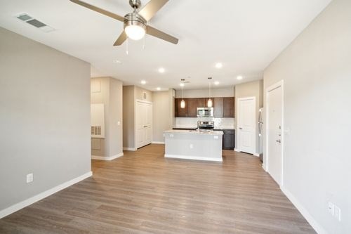 A spacious kitchen with a fan on the ceiling at Lockhart Farms Apartments, Lockhart