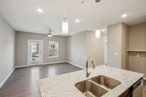 A kitchen with a sink and a ceiling fan at Lockhart Farms Apartments, Lockhart 78644