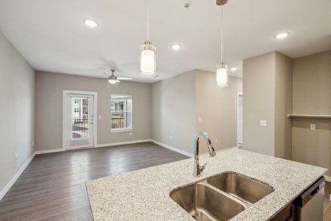 A kitchen with a sink and a ceiling fan.