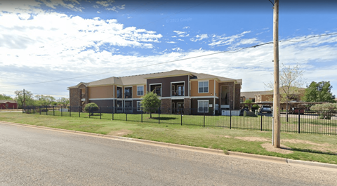 A building with a black fence in front of it.