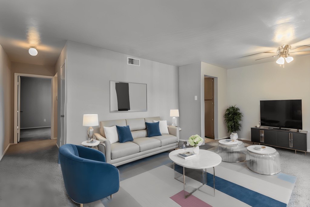 a living room with a couch and a table and a tv