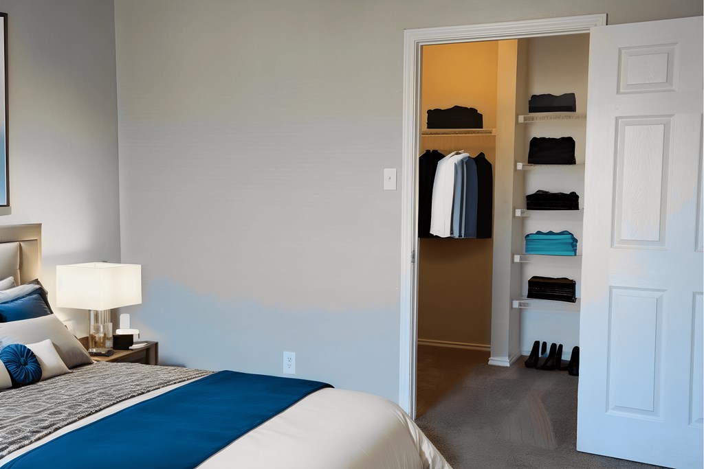 a bedroom with a bed and closet with a closet door open