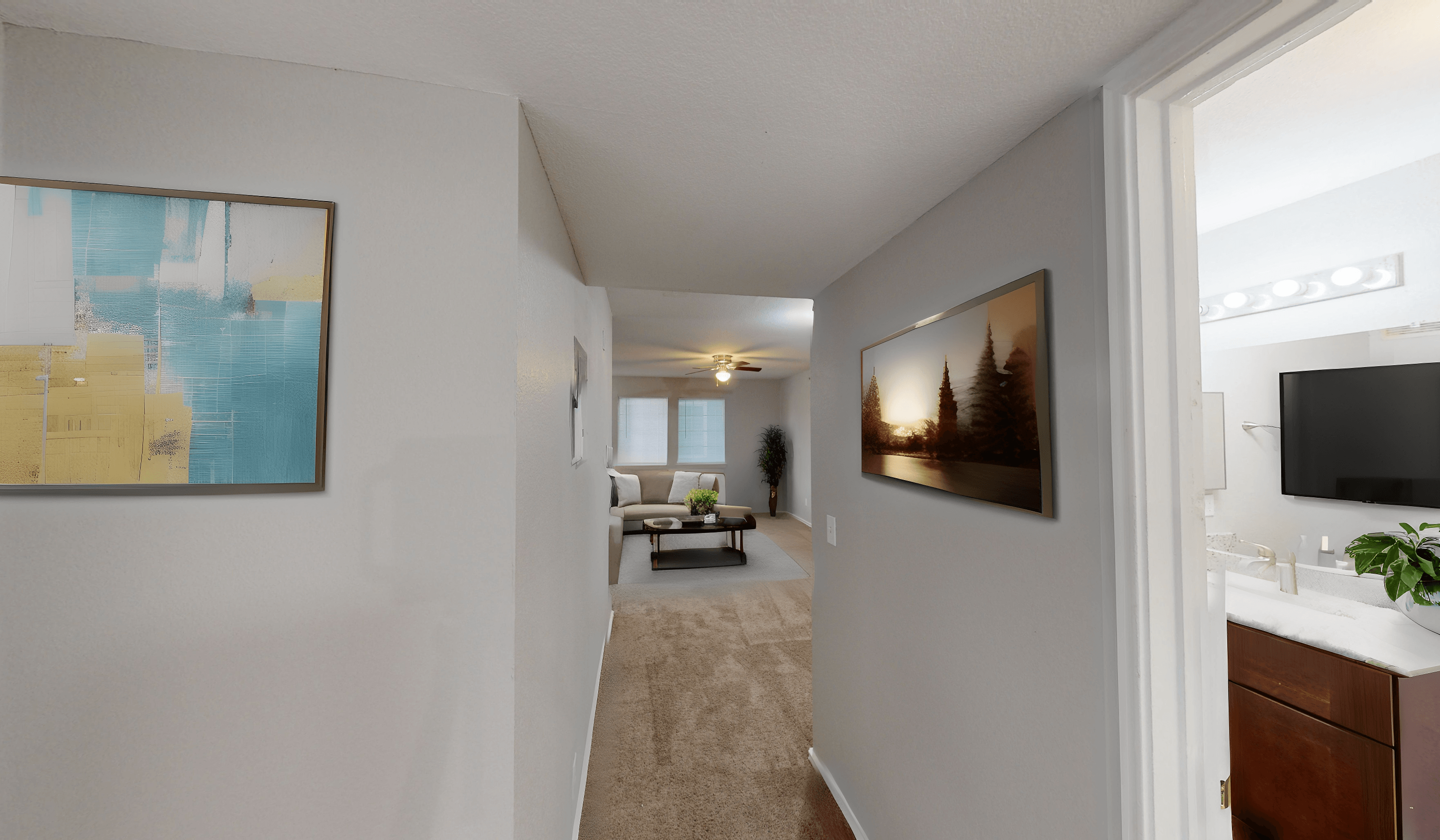 an open living room and hallway with a view of a dining room and living room