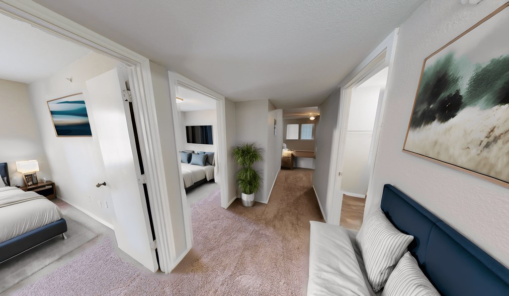 a living room with a couch and a view of a bedroom