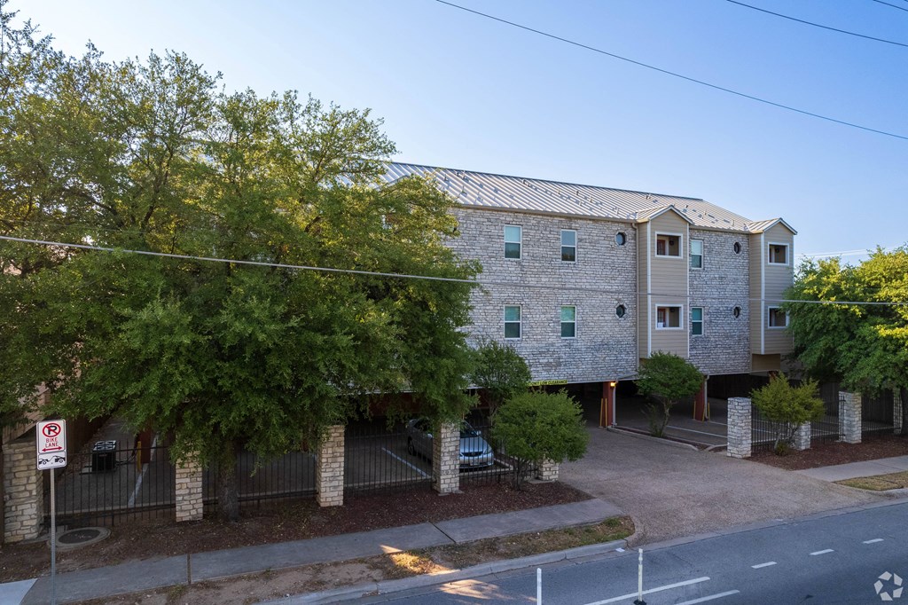 an apartment building on the corner of a street