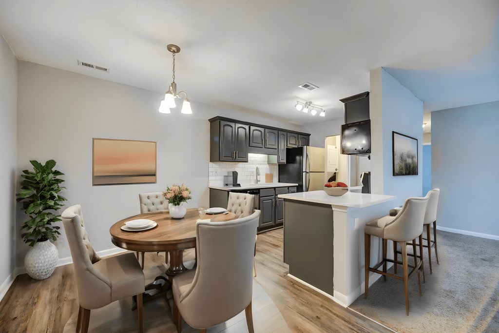 an open kitchen and dining room with a table and chairs and a kitchen and living