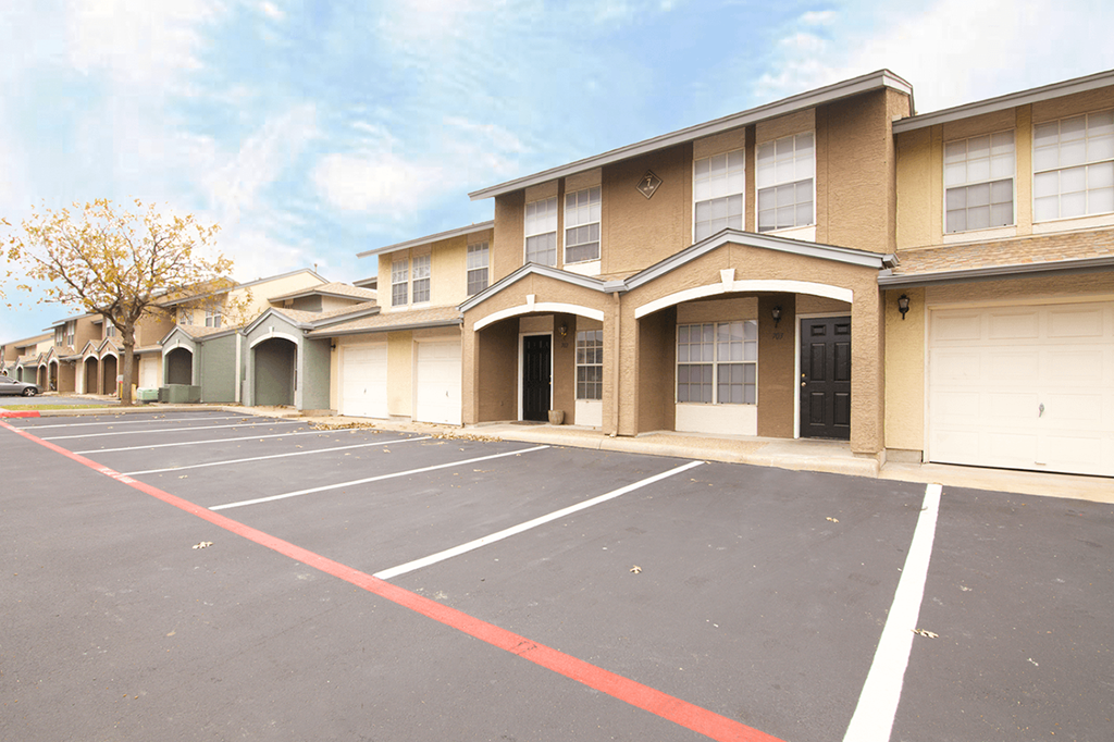 an empty parking lot in front of a building