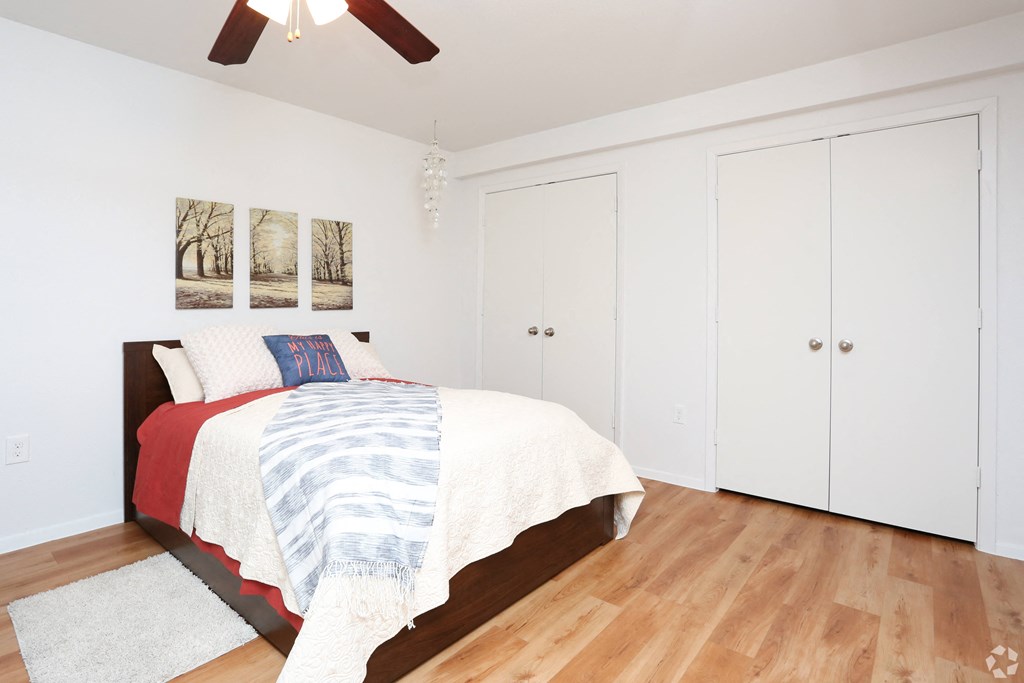 a bedroom with a bed and white closets