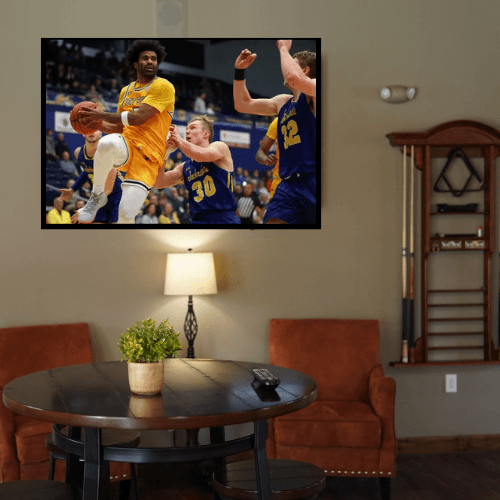 a room with a flat screen tv on the wall and a table and chairs in it
