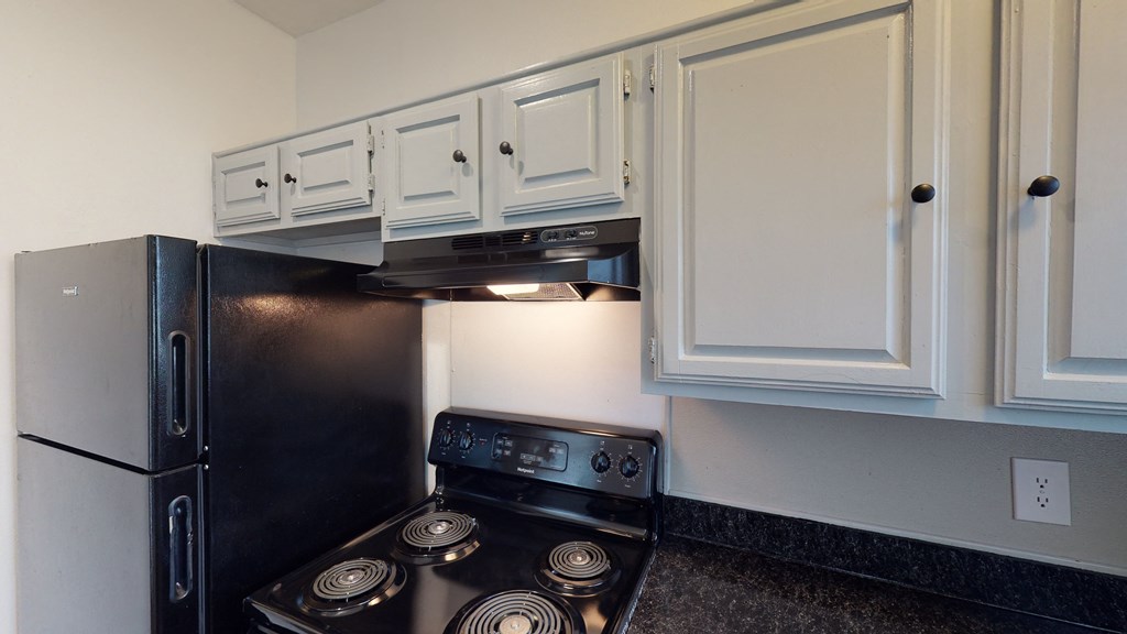 A black stove top oven with a silver handle.