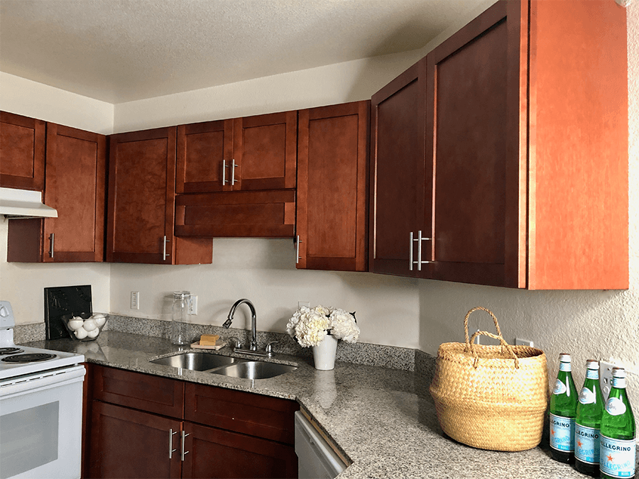 a kitchen with wood cabinets and granite countertops