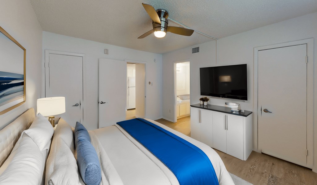 a bedroom with a large bed and a tv