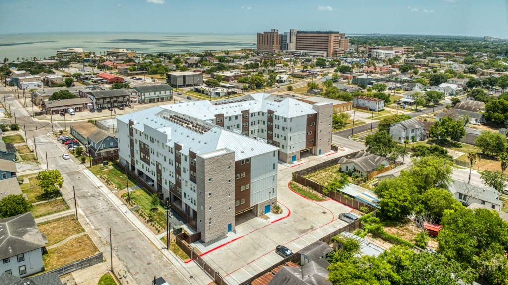an aerial view of a city with tall buildings