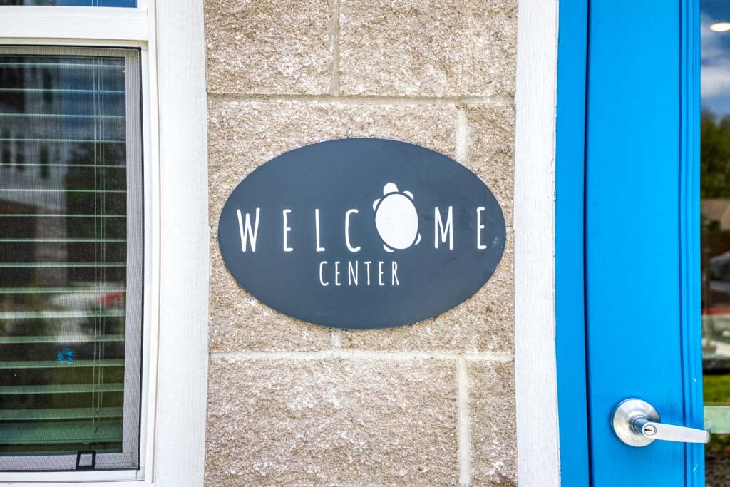 a sign on the side of a building with a dog