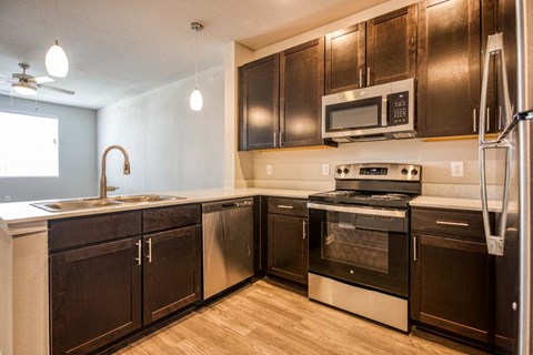 a kitchen with stainless steel appliances and wooden cabinets