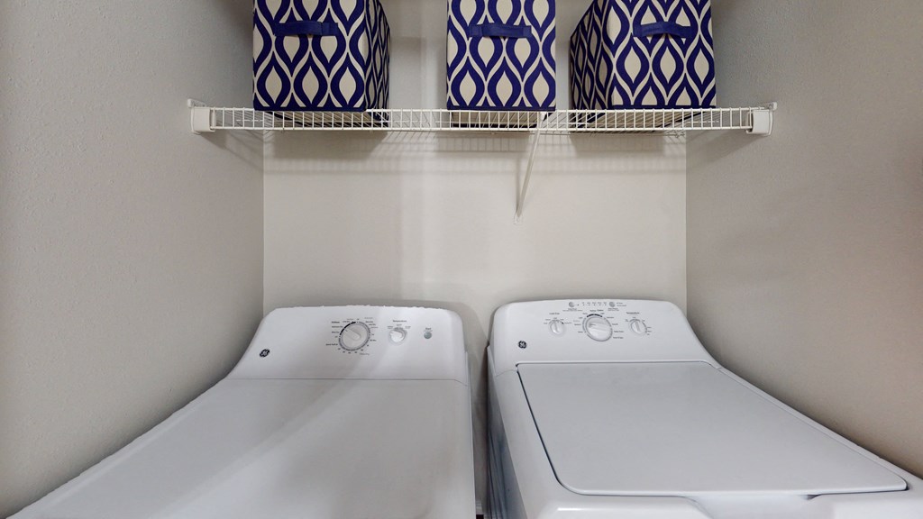 two washer and dryers in a clean laundry room