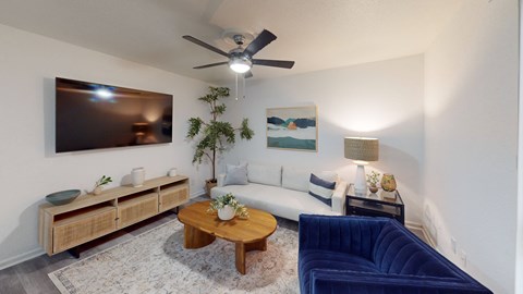 a living room with a couch and a ceiling fan