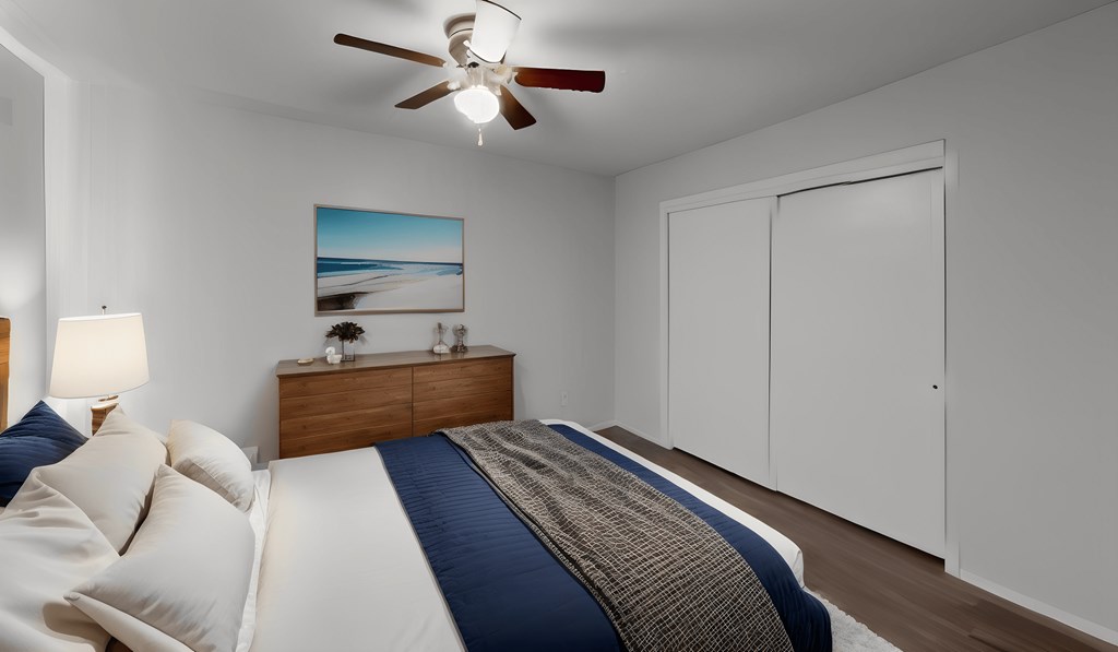 a bedroom with a bed and a ceiling fan