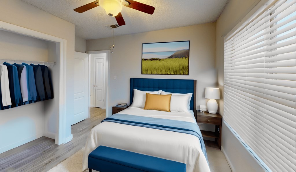 a bedroom with a large bed and a ceiling fan