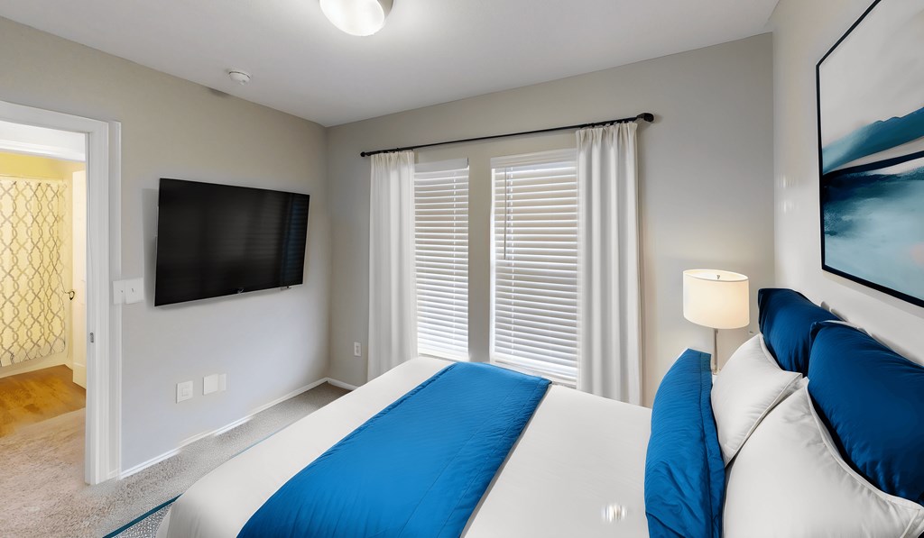 a bedroom with a large bed and a tv