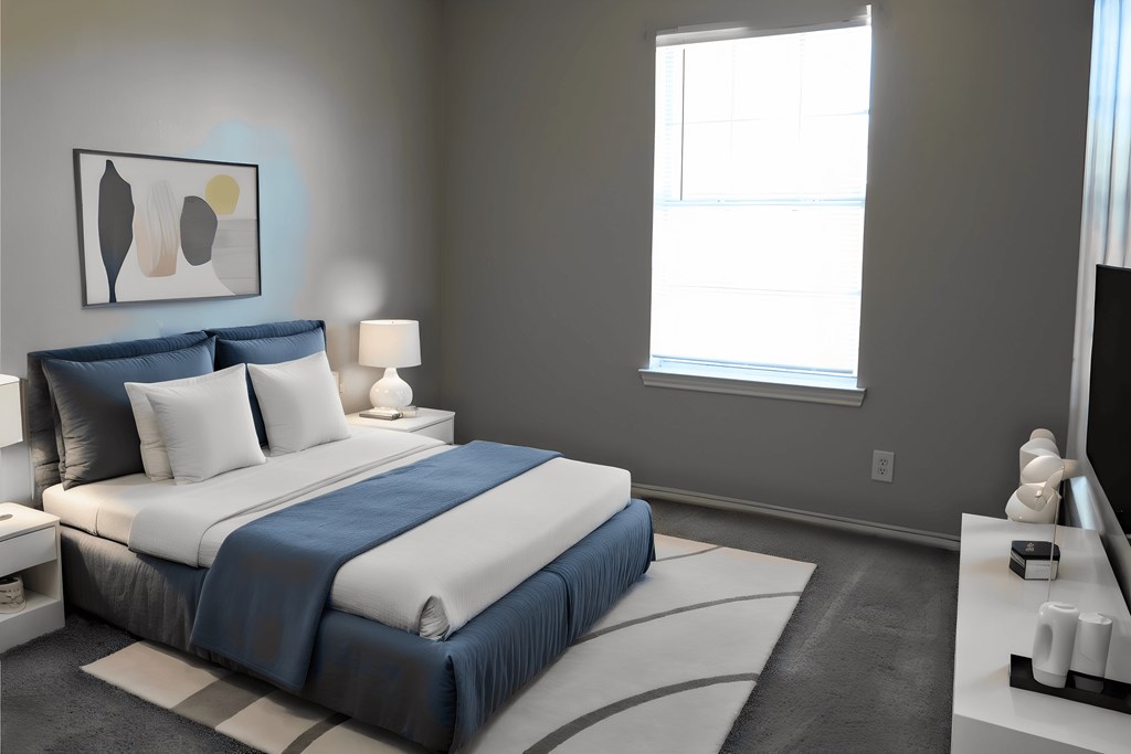 a blue and white bedroom with a bed and a window