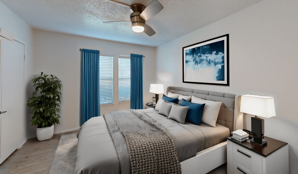 our spacious bedroom is equipped with a king size bed and a ceiling fan
