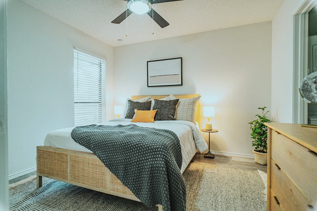 a bedroom with a bed and a ceiling fan