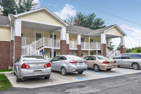 A parking lot with cars and a building in the background.