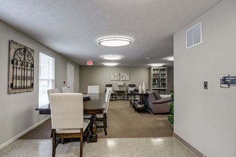 A dining room with a table and chairs.