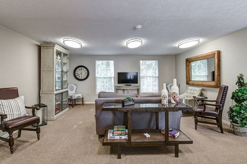 A living room with a couch, chair, and a coffee table.