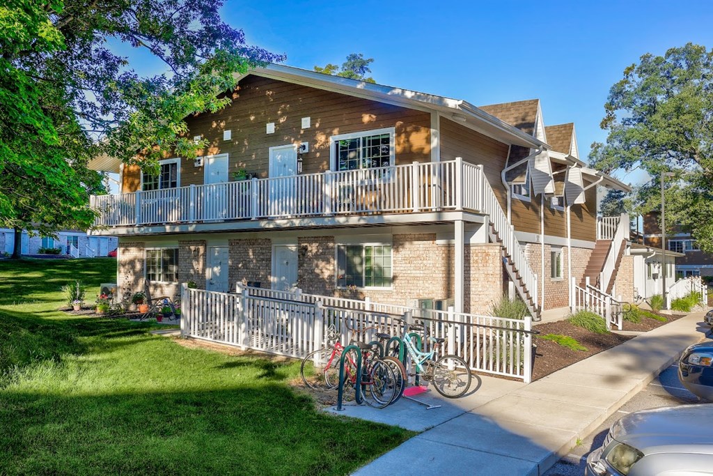 a large house with a balcony and two bikes parked in front of it