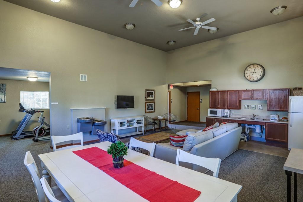 an open concept living room and kitchen with a dining table and chairs