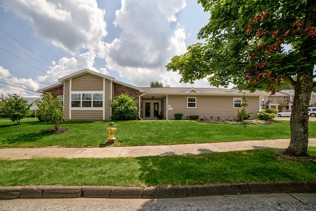 a house with a yellow fire hydrant in front of it