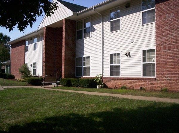 a white house with a sidewalk in front of it