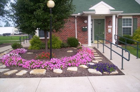 a flower garden in front of a building