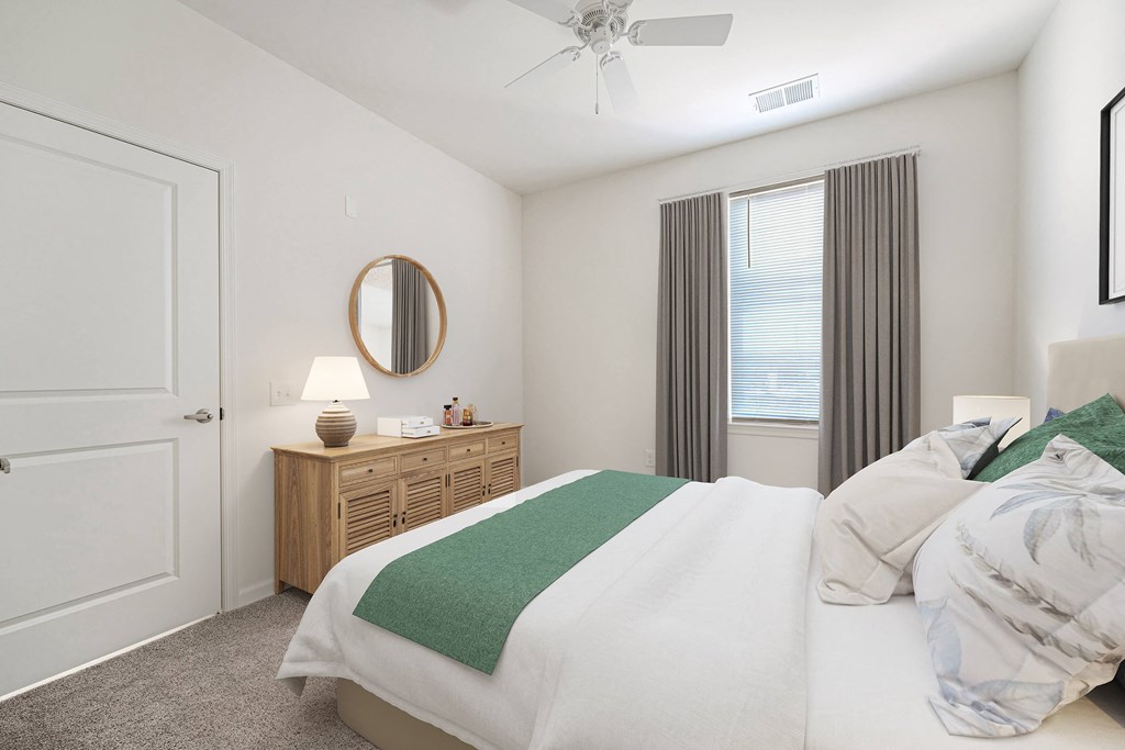 A bedroom with a bed, nightstand, and window.