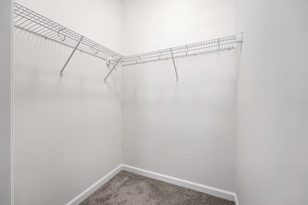 A white wall with a metal rack on it.