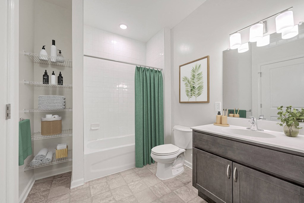 A bathroom with a toilet, sink, and a mirror.