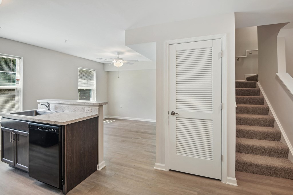 a kitchen with an island and stairs in a house