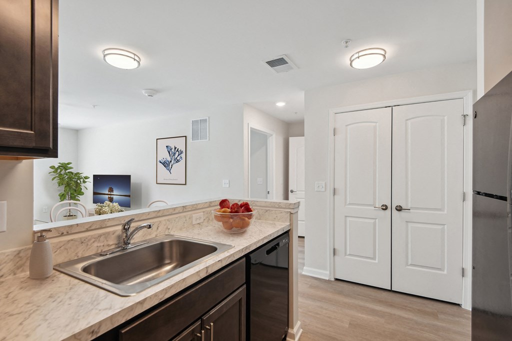 a kitchen with a sink and a door to a hallway