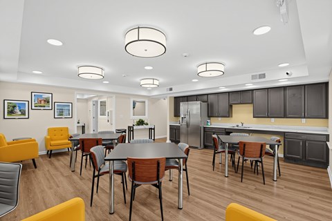 A modern kitchen and dining room with a table set for four.