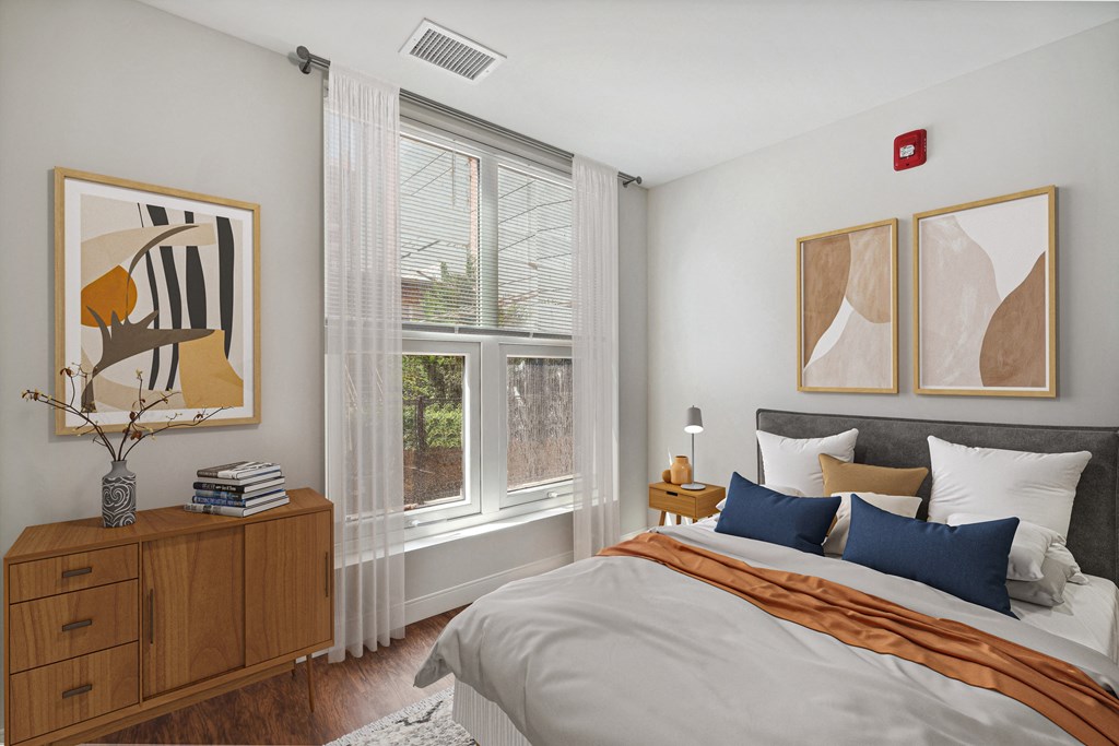 a bedroom with a bed and two windows