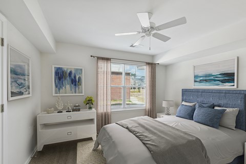 a bedroom with a large bed and a ceiling fan