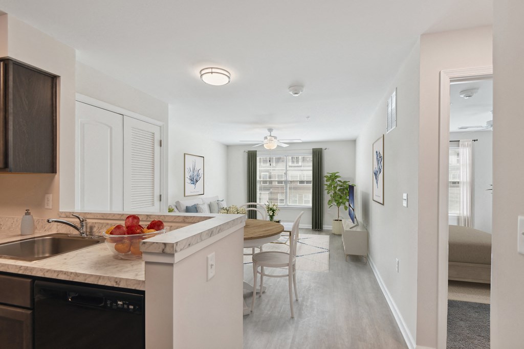 a kitchen and living room with a dining area and a living room