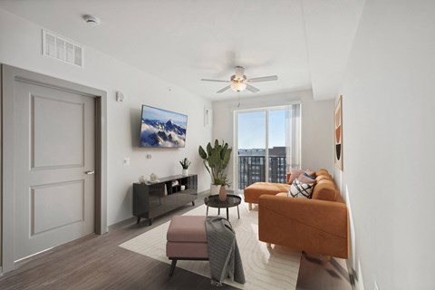 a living room with a couch and a ceiling fan